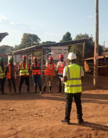 Tool box meeting conducted at Kagera Nkanda Village in Kigoma region where a 40kWp PV plant was under construction. This meeting is essential for health and safety awareness among team members implementing the project